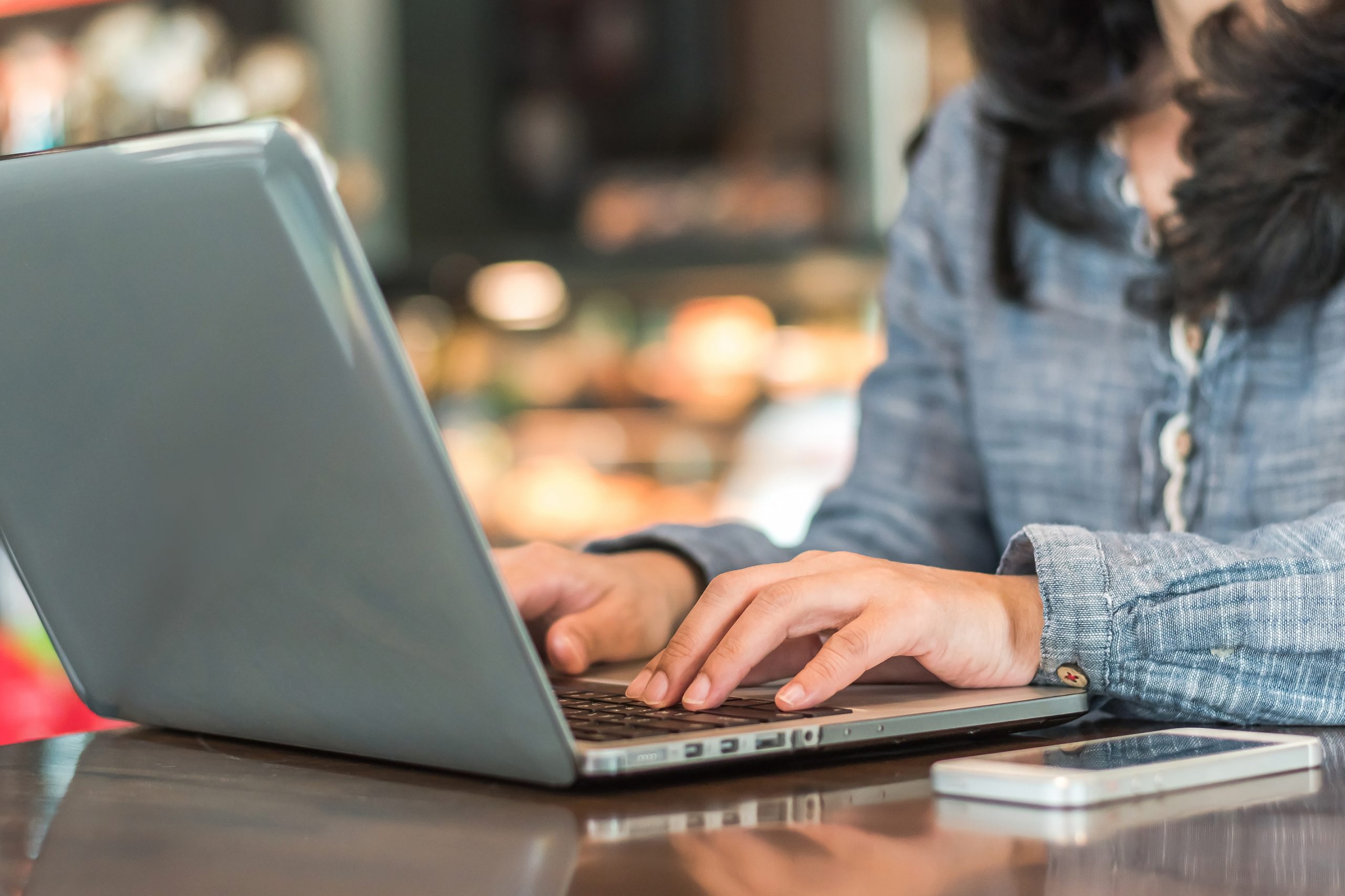 Woman working at laptop protecting e-mail communications in Devon
